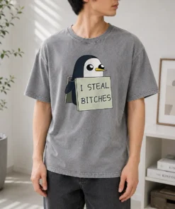 Top Gunter The Penguin I Steal Bitches Adventure Time printed on a soft washed t shirt in light gray